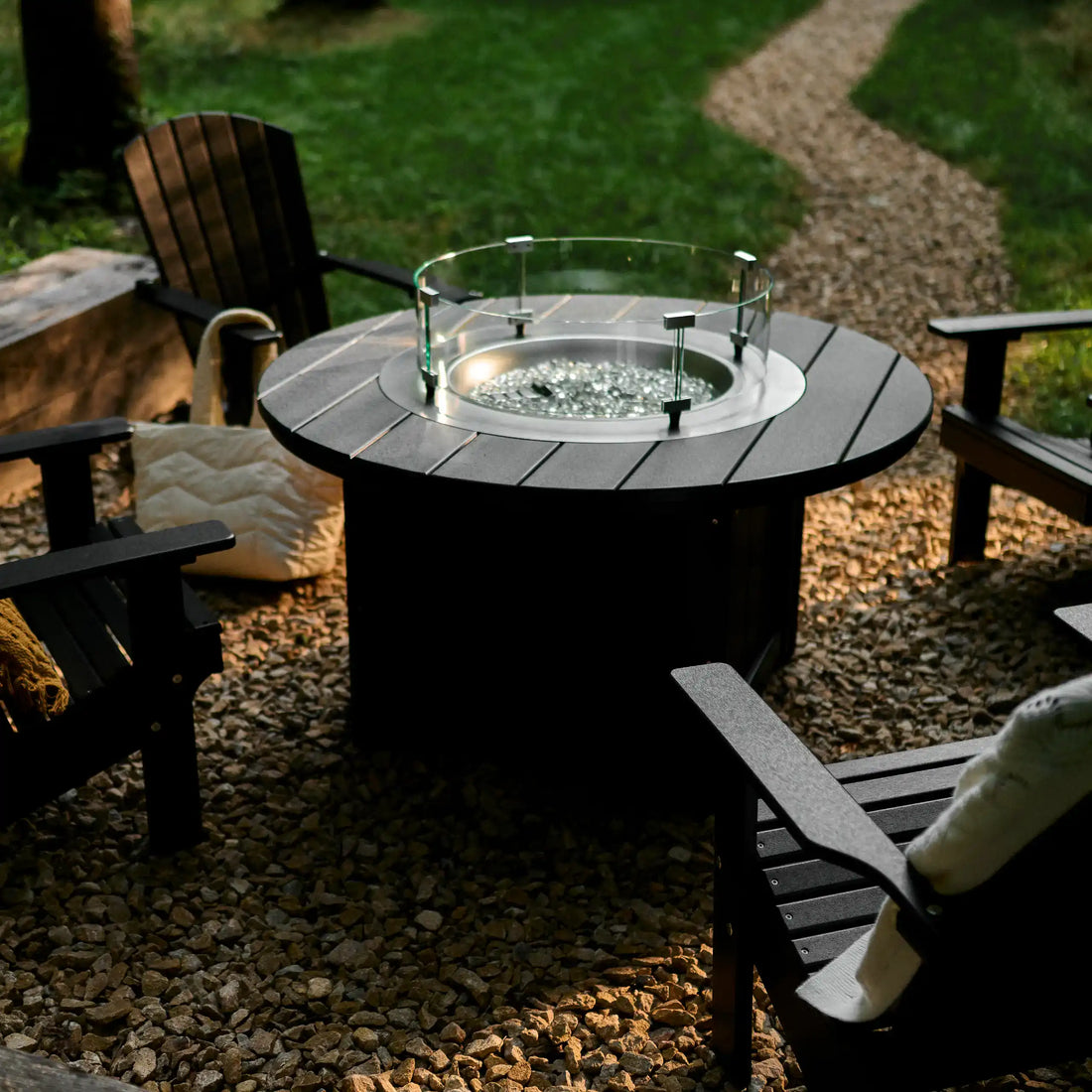 LuxCraft Lumin Fire Pit 46″ Round | LFP46R: Round tabletop and glass wind guard, viewed from above. Dark-finish example; chairs not included