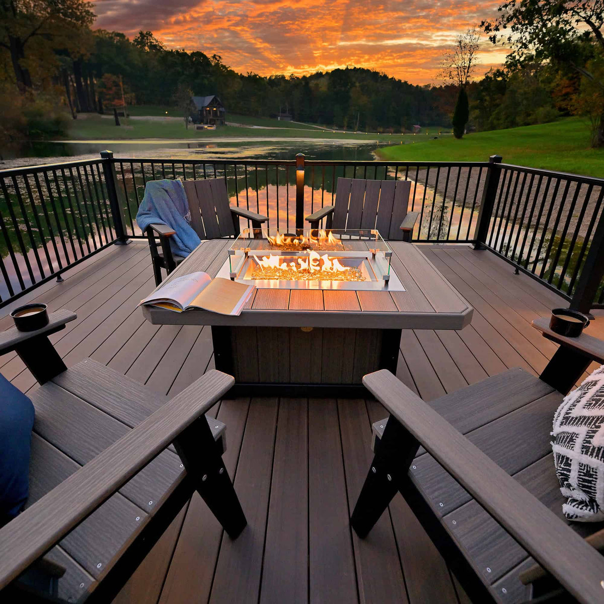 LuxCraft Lumin LFP51R 51-inch rectangular fire pit in the manufacturer outdoor setting, showing flames and glass wind guard; pictured chairs and accessories are not included