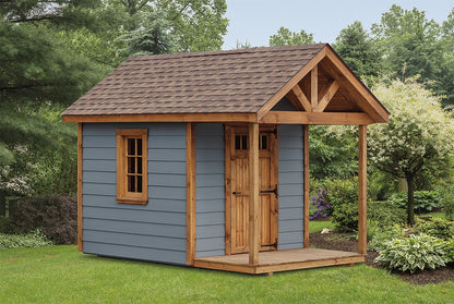 Heritage Garden Cottage Shed: grey exterior with a timber-accented covered porch and natural-wood door. Manufacturer example configuration; optional features may be shown.