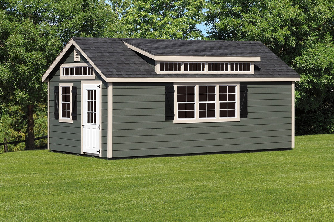 Heritage Garden Cottage Shed: green garden shed with transom windows and cream trim. Manufacturer example; size, finish and optional features vary.