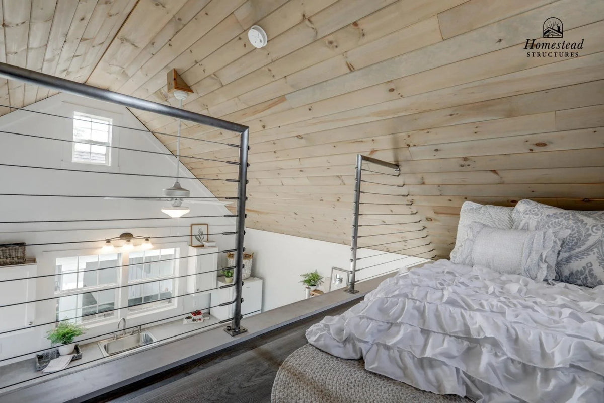 Homestead Structures Liberty Pool House: Optional loft interior example. Manufacturer project example; furnishings, appliances and optional finishes are not confirmed inclusions.