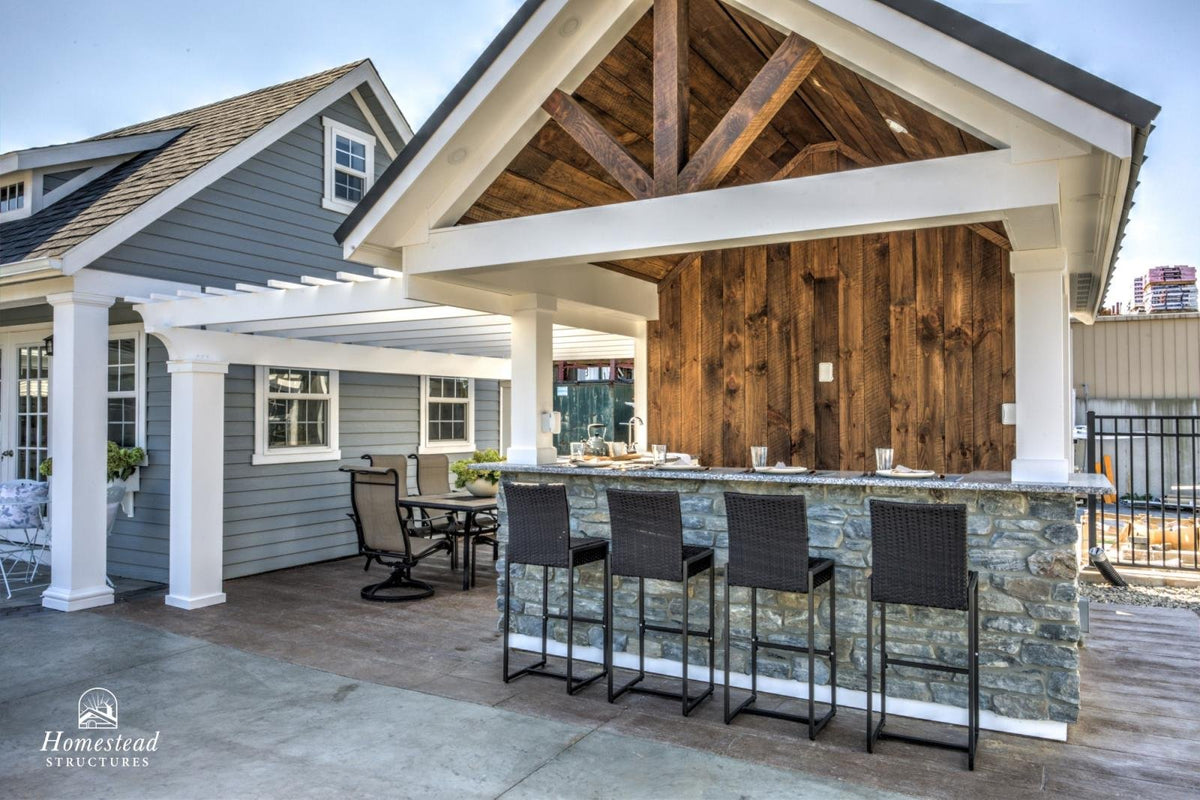 Homestead Structures Siesta Poolside Bar & Cabana: A-frame exterior and stone bar example. Manufacturer project example; furnishings, appliances and optional finishes are not confirmed inclusions.