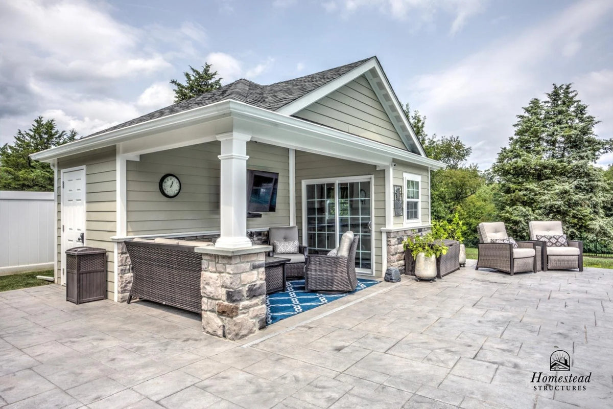Homestead Structures Wellington Pool House: Side exterior and covered living space. Manufacturer project example; furnishings, appliances and optional finishes are not confirmed inclusions.