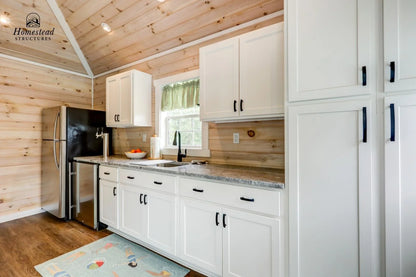 Homestead Structures Wellington Pool House: Optional finished kitchen interior. Manufacturer project example; furnishings, appliances and optional finishes are not confirmed inclusions.
