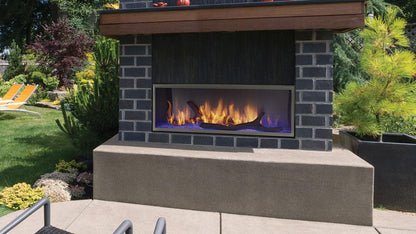 Outdoor Lifestyles Lanai 48-inch fireplace with blue lighting in a manufacturer example installation; optional driftwood logs, screen, surround and furnishings are not included
