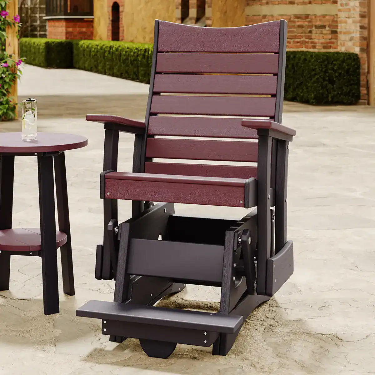 LuxCraft 2COPBAG, supplier patio view in a reddish-brown and dark finish, showing the chair, glider base and raised foot platform. Manufacturer finish/configuration example; select the desired options separately. Other furniture, throw pillows, blankets and decorative accessories are not included.