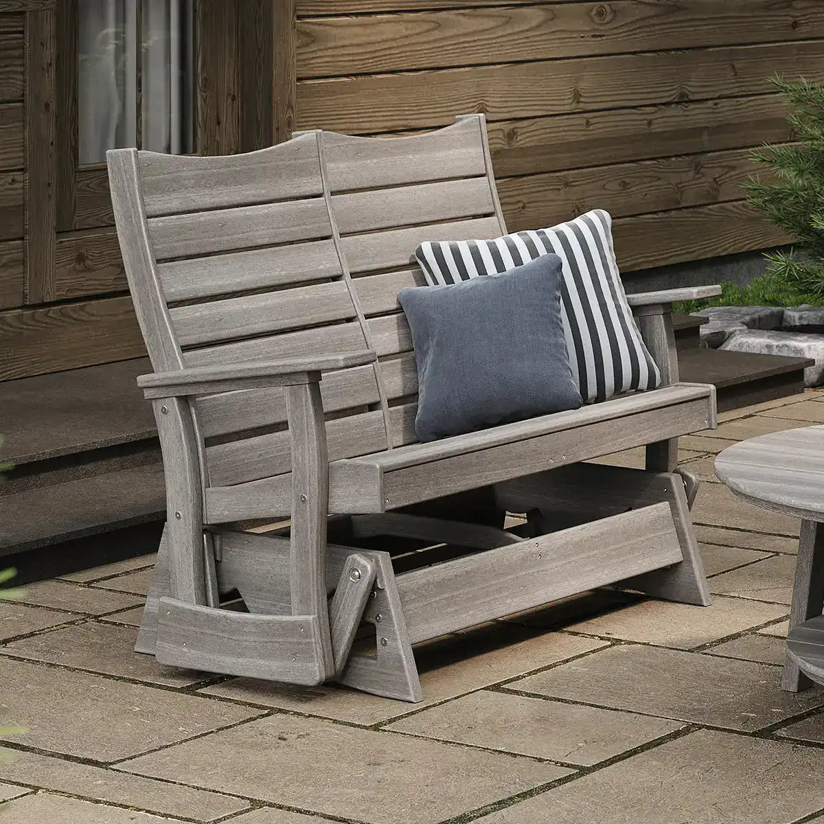 LuxCraft 4COPG, supplier angled patio view in a gray finish, showing the 4-foot Contour Glider seat, arms and base. Manufacturer finish/configuration example; select the desired options separately. Other furniture, throw pillows, blankets and decorative accessories are not included.