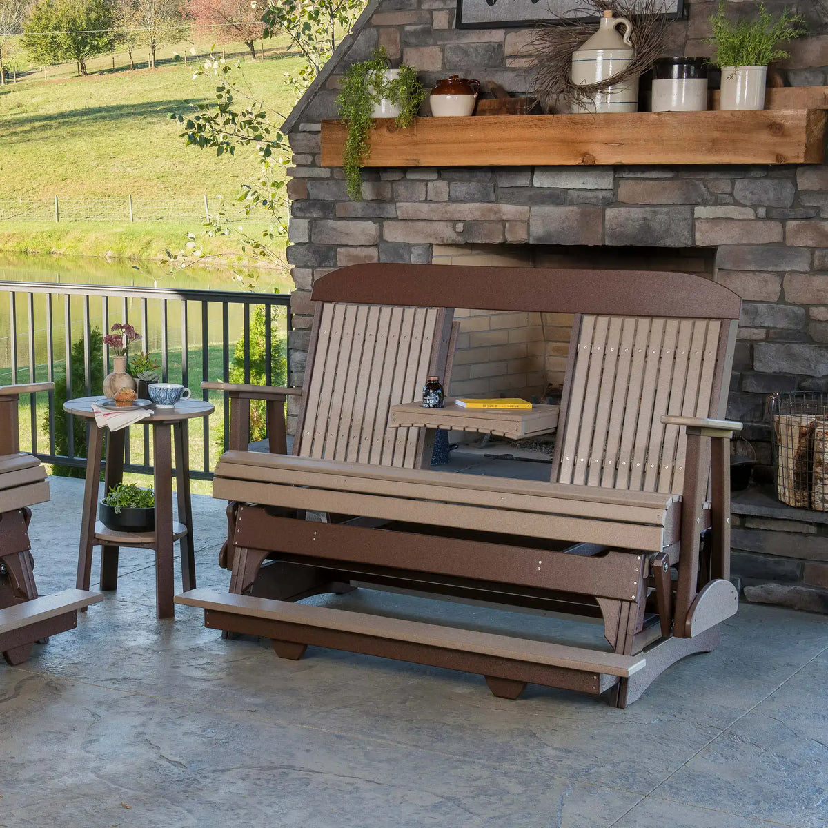 LuxCraft 5CPBAG, supplier covered-patio view in a brown finish, showing the wide seat, center tray and raised foot platform. Manufacturer finish/configuration example; select the desired options separately. Other furniture, throw pillows, blankets and decorative accessories are not included.