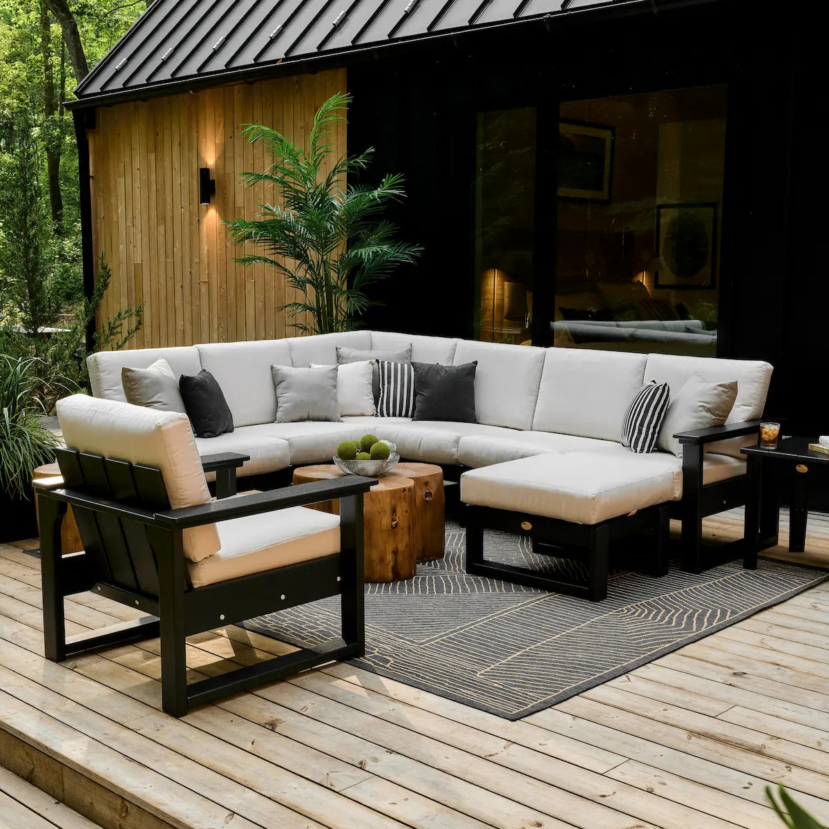 LuxCraft Lanai Deep Seating Sectional in a styled outdoor setting; separate chair, ottoman, tables and accessories are not included