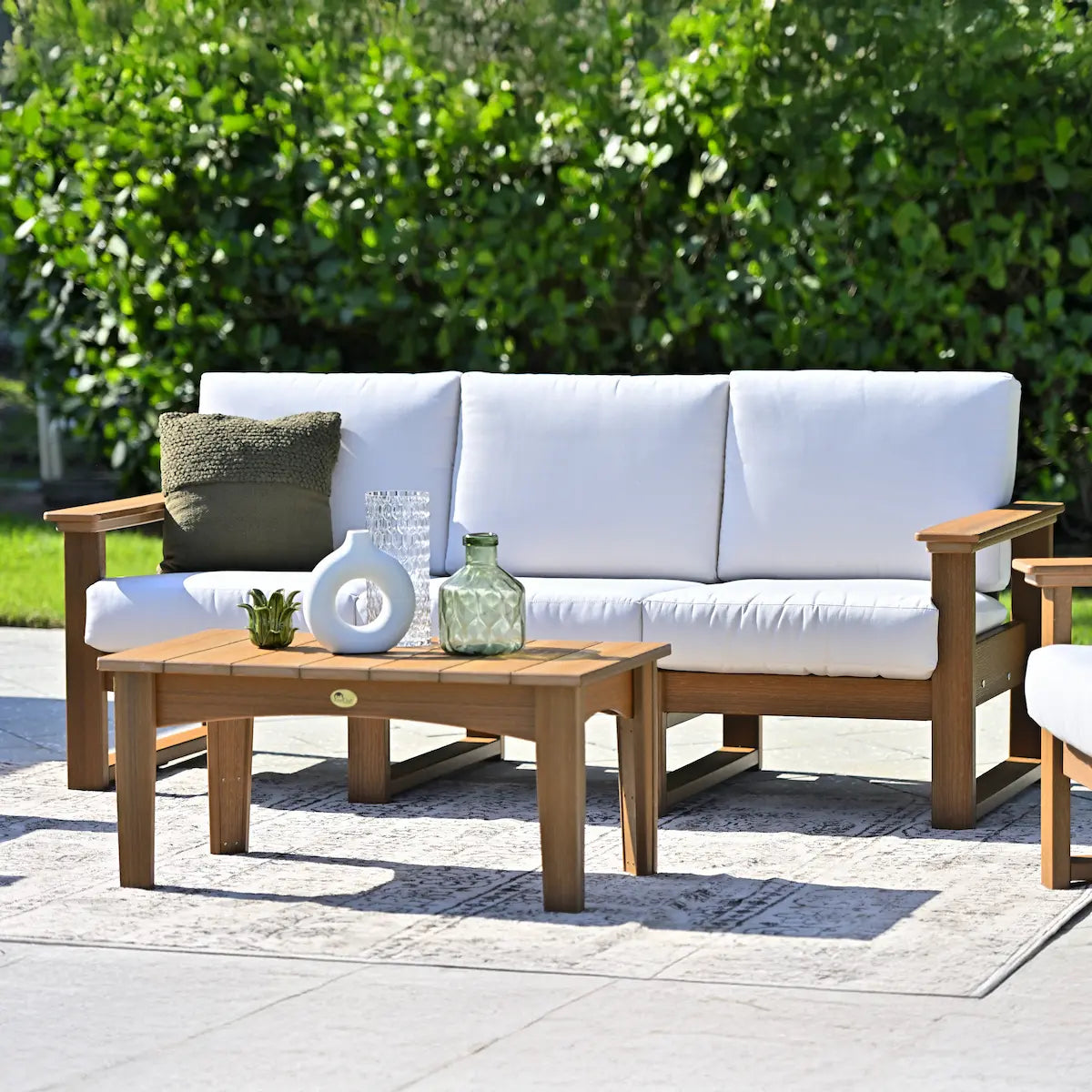 LuxCraft LDSS, supplier front poolside view in a woodgrain-look frame with light cushions. Manufacturer finish/configuration example; select the desired options separately. Other furniture, throw pillows, blankets and decorative accessories are not included.