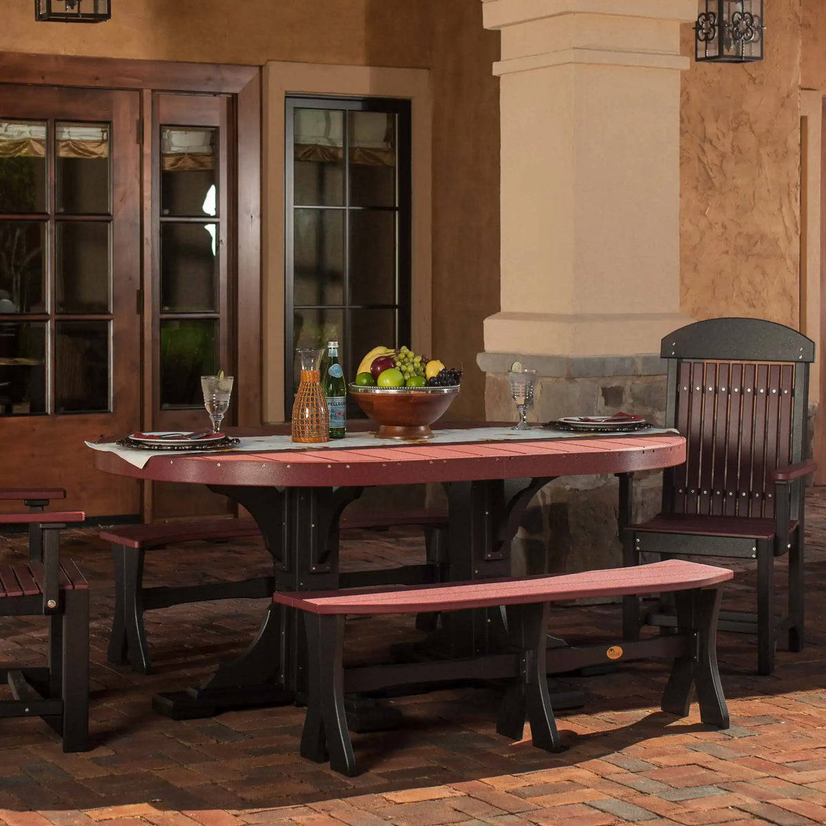 LuxCraft P46OT, supplier covered-patio view of the oval tabletop and pedestal base in a two-tone reddish-brown and dark finish. Manufacturer finish/configuration example; select the desired options separately. Other furniture, throw pillows, blankets and decorative accessories are not included.