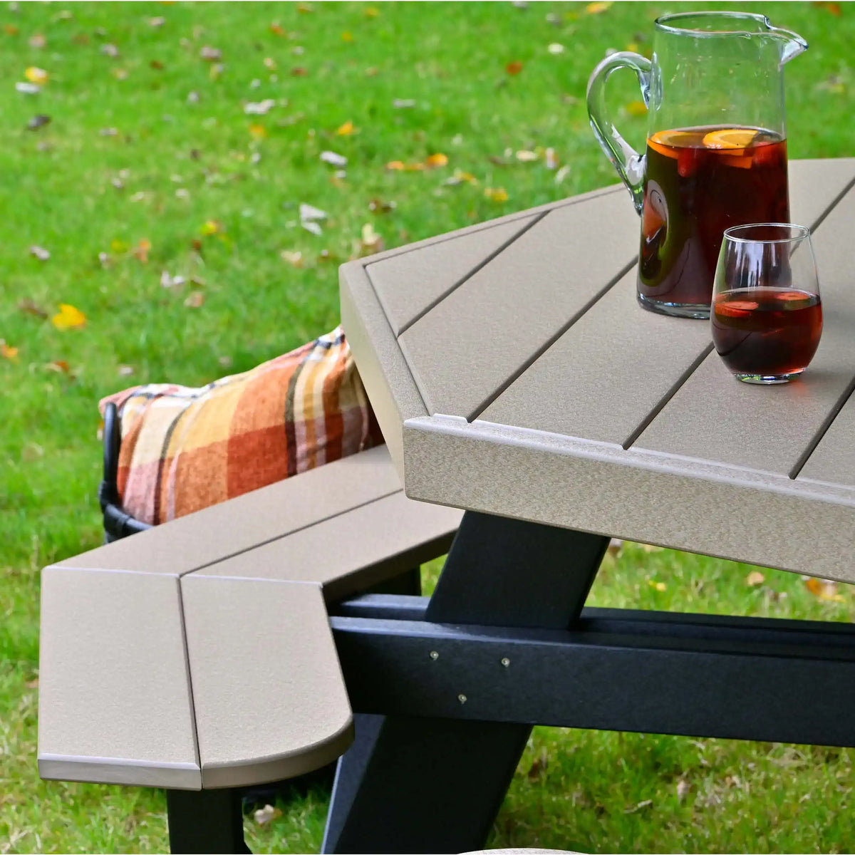 LuxCraft POPT, supplier closeup of the octagonal tabletop edge, attached bench and dark support frame. Manufacturer finish/configuration example; select the desired options separately. Tableware, blankets and decorative accessories are not included.