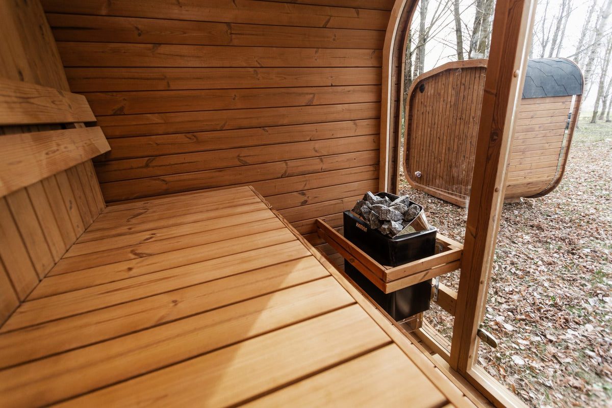 Mande Spa MW16 Outdoor Sauna — Up to 4 Person, manufacturer photograph: interior glazing and heater position; example configuration, options may vary