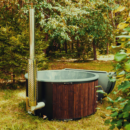Mande Spa MWT4 wood-fired hot tub, manufacturer alternate front and side view with exterior flue at left and opened cover at right; supplier example configuration
