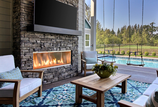 Outdoor Lifestyles Lanai 48 fireplace shown installed in a stone surround; surround and furnishings not included