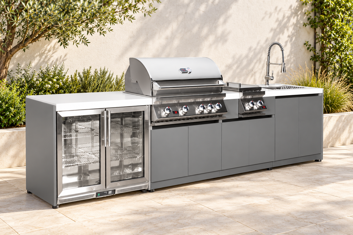 Whistler CBB4 four-module outdoor kitchen with grill, double side burner, double-door refrigerator and sink in an illustrative patio setting based on the supplier configuration